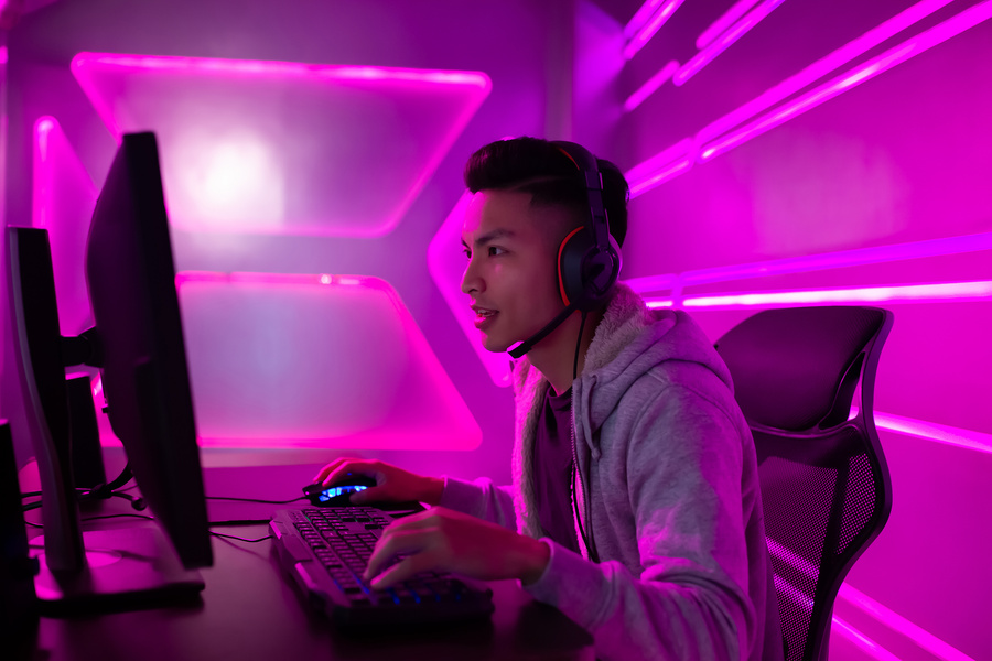 Young Handsome Gamer Playing on Desktop Computer